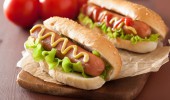 hot dog with ketchup mustard and lettuce
